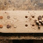woodworking plugs different sizes placed near screw holes in oak wood plank on rustic workbench